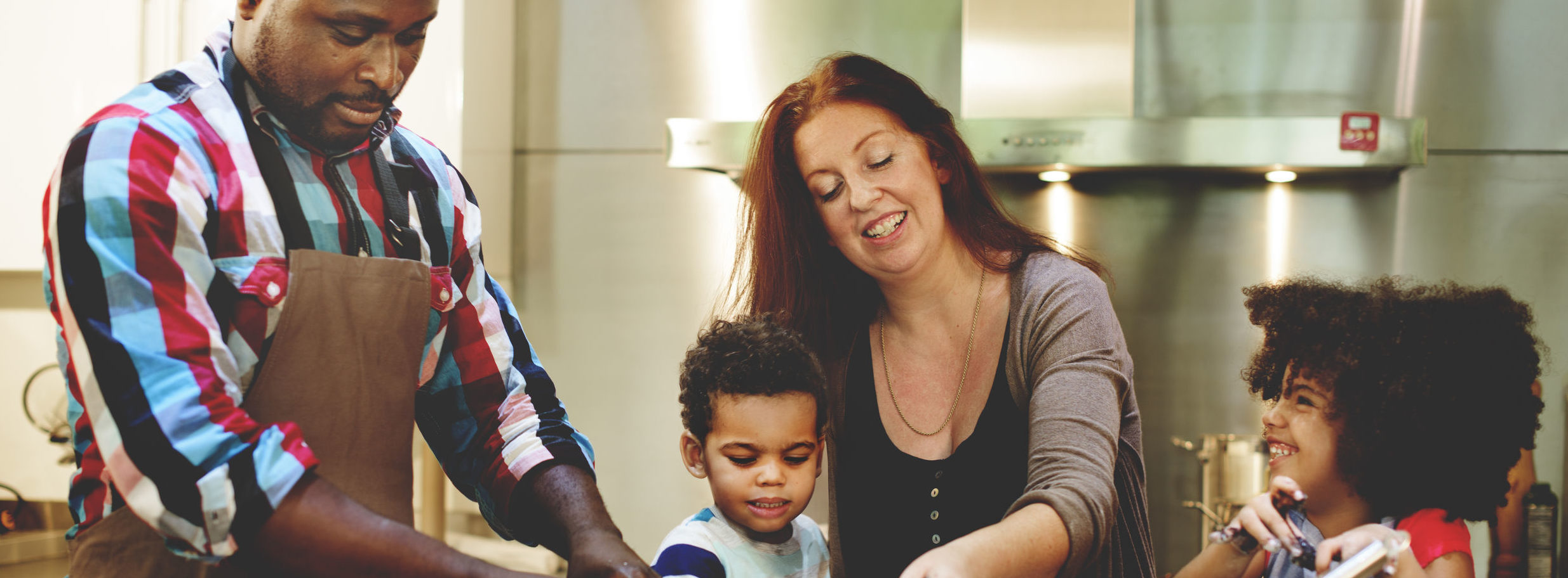 Family smiling cooking together