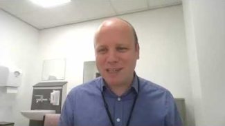 Photo taken of physiotherapist Will Gregory in his consultation room while speaking about virtual consultations