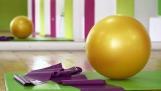 Photo of an exercise mat, resistance band and exercise ball