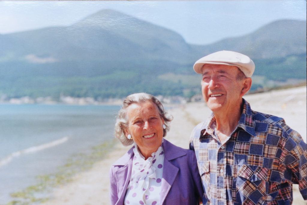Frank Murray and his wife on a beach